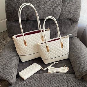 White quilted purse. Comes with identical smaller purse, wallet, shoulder strap.